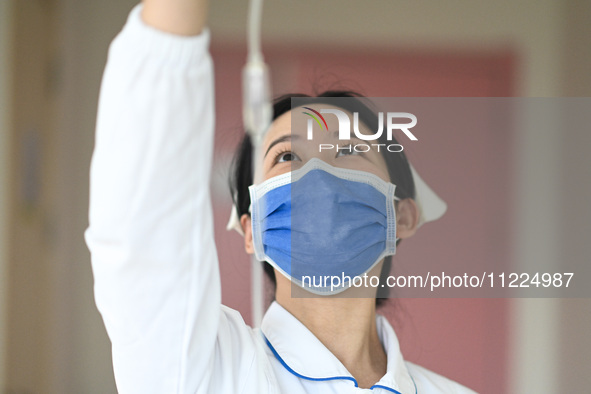 A nurse is inspecting the infusion of a hospitalized child at the otolaryngology department of Jiangxi Children's Hospital in Nanchang, Jian...