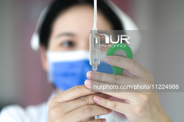 A nurse is checking the number of infusion drops at the otolaryngology department of Jiangxi Children's Hospital in Nanchang, Jiangxi Provin...