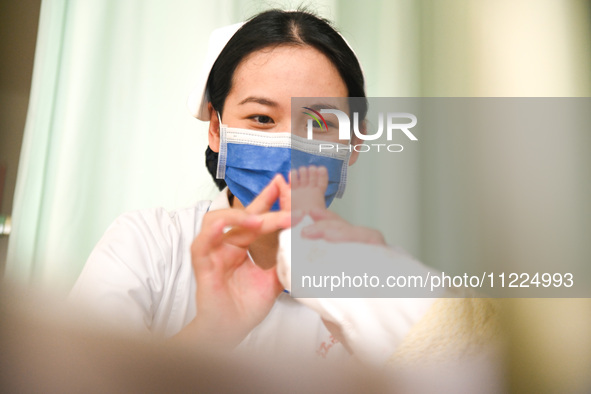 A nurse is checking a hospitalized child at the otolaryngology department of Jiangxi Children's Hospital in Nanchang, Jiangxi Province, Chin...