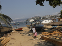 A person is walking between destroyed boats on the shore of Tamarindos Beach in Acapulco, Mexico, on April 17, 2024, six months after Hurric...