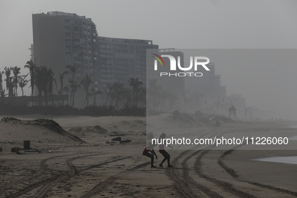 Tourists are enjoying the beach while hotels appear destroyed at Riviera Punta Diamante in Acapulco, Guerrero, six months after Hurricane Ot...