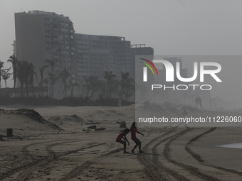 Tourists are enjoying the beach while hotels appear destroyed at Riviera Punta Diamante in Acapulco, Guerrero, six months after Hurricane Ot...