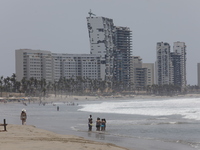 Tourists are enjoying the beach while hotels appear destroyed at Riviera Punta Diamante in Acapulco, Guerrero, six months after Hurricane Ot...