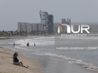 Tourists are enjoying the beach while hotels appear destroyed at Riviera Punta Diamante in Acapulco, Guerrero, six months after Hurricane Ot...