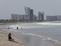 Tourists are enjoying the beach while hotels appear destroyed at Riviera Punta Diamante in Acapulco, Guerrero, six months after Hurricane Ot...