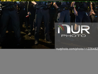 DC police with batons in hand prepare to arrest students for trespassing on George Washington University property, Washington, DC, May 9, 20...