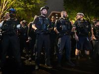 DC police with batons in hand prepare to arrest students for trespassing on George Washington University property, Washington, DC, May 9, 20...