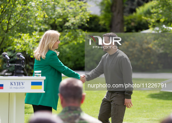 Presidents Volodymyr Zelenskyy of Ukraine and Zuzana Caputova of Slovakia are shaking hands during a joint briefing in Kyiv, Ukraine, on May...