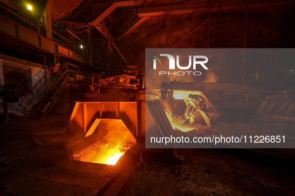 A worker is performing his duties in a blast furnace shop at Zaporizhstal Iron and Steel Works in Zaporizhzhia, Ukraine, on May 3, 2024. 