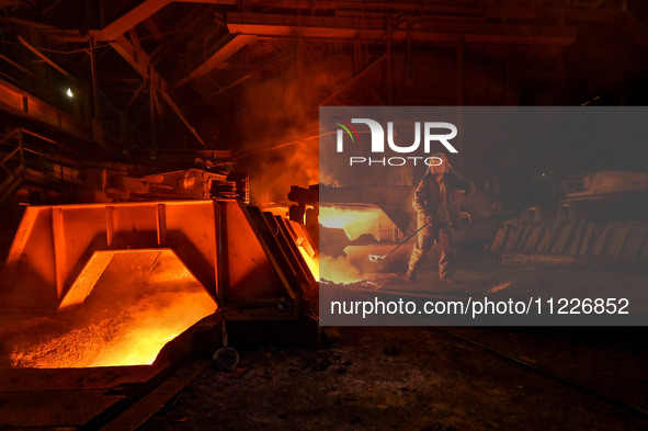 A worker is performing his duties in a blast furnace shop at Zaporizhstal Iron and Steel Works in Zaporizhzhia, Ukraine, on May 3, 2024. 