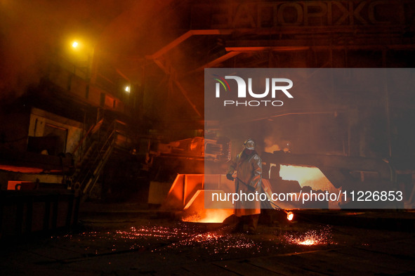 A worker is performing his duties in a blast furnace shop at Zaporizhstal Iron and Steel Works in Zaporizhzhia, Ukraine, on May 3, 2024. 