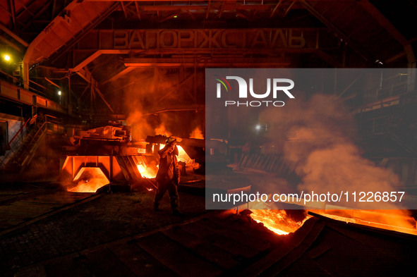 A worker is performing his duties in a blast furnace shop at Zaporizhstal Iron and Steel Works in Zaporizhzhia, Ukraine, on May 3, 2024. 