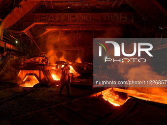 A worker is performing his duties in a blast furnace shop at Zaporizhstal Iron and Steel Works in Zaporizhzhia, Ukraine, on May 3, 2024. (