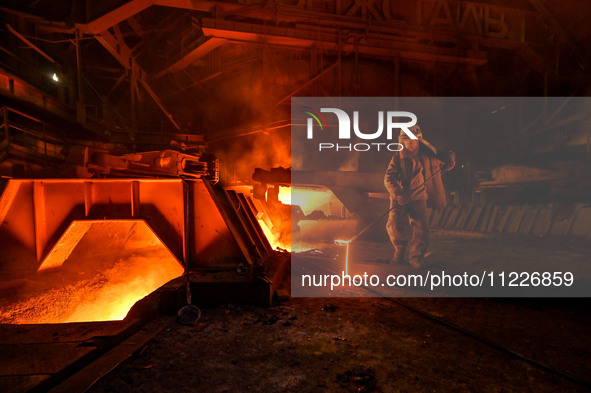 A worker is performing his duties in a blast furnace shop at Zaporizhstal Iron and Steel Works in Zaporizhzhia, Ukraine, on May 3, 2024. 