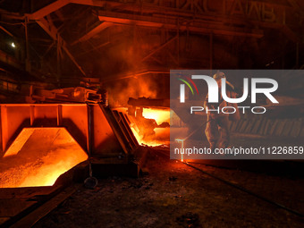 A worker is performing his duties in a blast furnace shop at Zaporizhstal Iron and Steel Works in Zaporizhzhia, Ukraine, on May 3, 2024. (