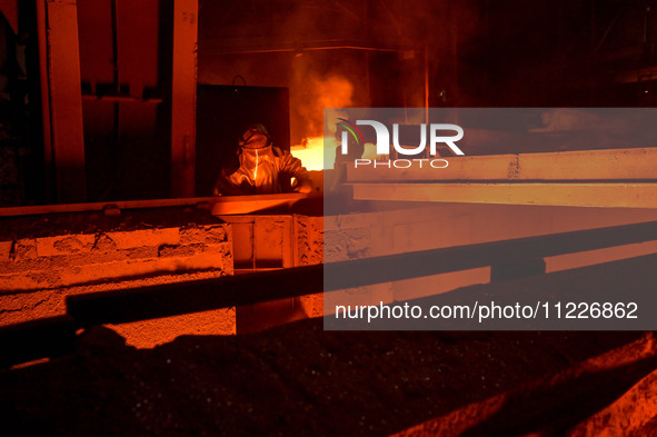 A worker is performing his duties in a blast furnace shop at Zaporizhstal Iron and Steel Works in Zaporizhzhia, Ukraine, on May 3, 2024. 