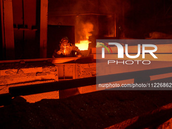 A worker is performing his duties in a blast furnace shop at Zaporizhstal Iron and Steel Works in Zaporizhzhia, Ukraine, on May 3, 2024. (