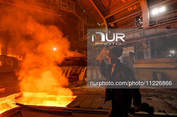 A worker is performing his duties in a blast furnace shop at Zaporizhstal Iron and Steel Works in Zaporizhzhia, Ukraine, on May 3, 2024. 