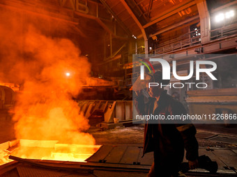 A worker is performing his duties in a blast furnace shop at Zaporizhstal Iron and Steel Works in Zaporizhzhia, Ukraine, on May 3, 2024. (