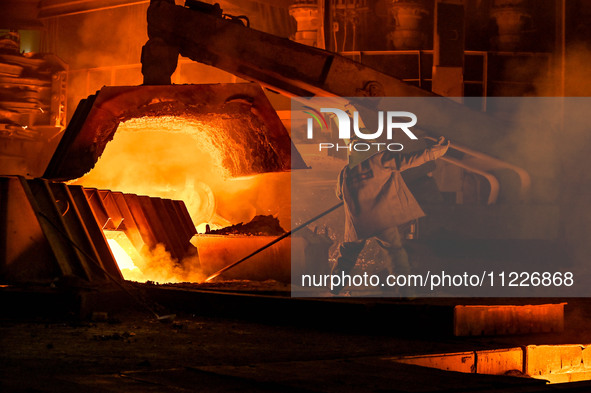 A worker is performing his duties in a blast furnace shop at Zaporizhstal Iron and Steel Works in Zaporizhzhia, Ukraine, on May 3, 2024. 