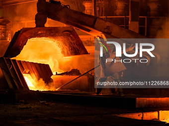 A worker is performing his duties in a blast furnace shop at Zaporizhstal Iron and Steel Works in Zaporizhzhia, Ukraine, on May 3, 2024. (