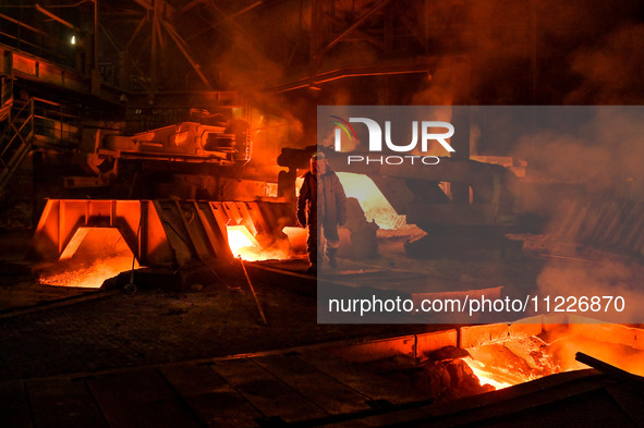 A worker is performing his duties in a blast furnace shop at Zaporizhstal Iron and Steel Works in Zaporizhzhia, Ukraine, on May 3, 2024. 