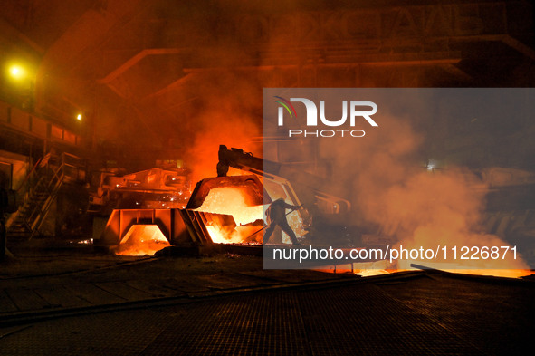 A worker is performing his duties in a blast furnace shop at Zaporizhstal Iron and Steel Works in Zaporizhzhia, Ukraine, on May 3, 2024. 