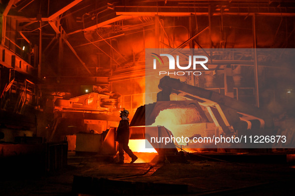 A worker is performing his duties in a blast furnace shop at Zaporizhstal Iron and Steel Works in Zaporizhzhia, Ukraine, on May 3, 2024. 