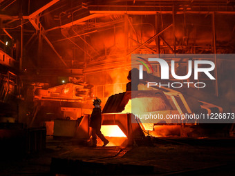 A worker is performing his duties in a blast furnace shop at Zaporizhstal Iron and Steel Works in Zaporizhzhia, Ukraine, on May 3, 2024. (