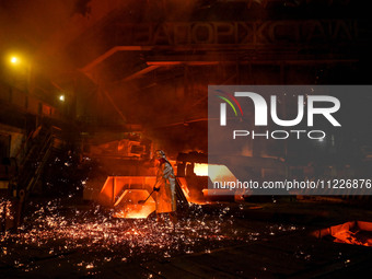 A worker is performing his duties in a blast furnace shop at Zaporizhstal Iron and Steel Works in Zaporizhzhia, Ukraine, on May 3, 2024. (