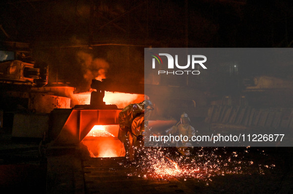 Workers are performing their duties in a blast furnace shop at Zaporizhstal Iron and Steel Works in Zaporizhzhia, southeastern Ukraine, on M...