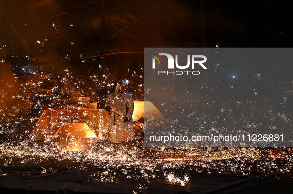 A worker is performing his duties in a blast furnace shop at Zaporizhstal Iron and Steel Works in Zaporizhzhia, Ukraine, on May 3, 2024. 