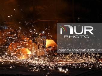 A worker is performing his duties in a blast furnace shop at Zaporizhstal Iron and Steel Works in Zaporizhzhia, Ukraine, on May 3, 2024. (