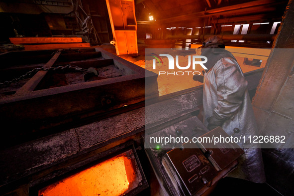 A worker is performing his duties in a blast furnace shop at Zaporizhstal Iron and Steel Works in Zaporizhzhia, Ukraine, on May 3, 2024. 