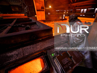 A worker is performing his duties in a blast furnace shop at Zaporizhstal Iron and Steel Works in Zaporizhzhia, Ukraine, on May 3, 2024. (