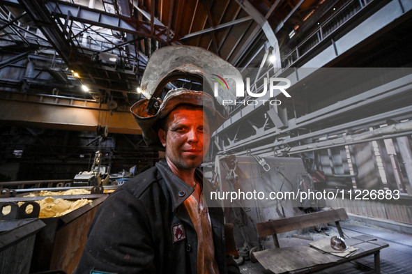 A worker is posing for a picture in a blast furnace shop at Zaporizhstal Iron and Steel Works in Zaporizhzhia, Ukraine, on May 3, 2024. 