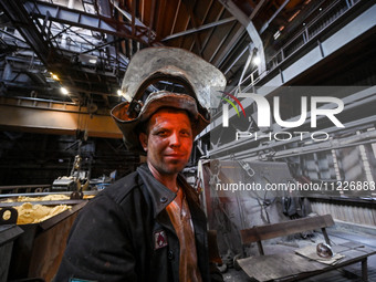 A worker is posing for a picture in a blast furnace shop at Zaporizhstal Iron and Steel Works in Zaporizhzhia, Ukraine, on May 3, 2024. (