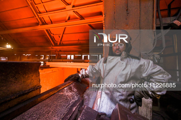 A worker is posing for a picture in a blast furnace shop at Zaporizhstal Iron and Steel Works in Zaporizhzhia, Ukraine, on May 3, 2024. 