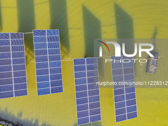 Employees of State Grid Fuzhou Power Supply Company are inspecting photovoltaic equipment in Xincuo town, Fuqing city, Fujian province, Chin...