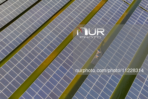 Employees of State Grid Fuzhou Power Supply Company are inspecting photovoltaic equipment in Xincuo town, Fuqing city, Fujian province, Chin...