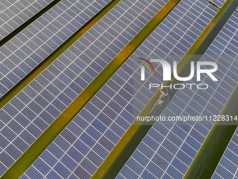 Employees of State Grid Fuzhou Power Supply Company are inspecting photovoltaic equipment in Xincuo town, Fuqing city, Fujian province, Chin...