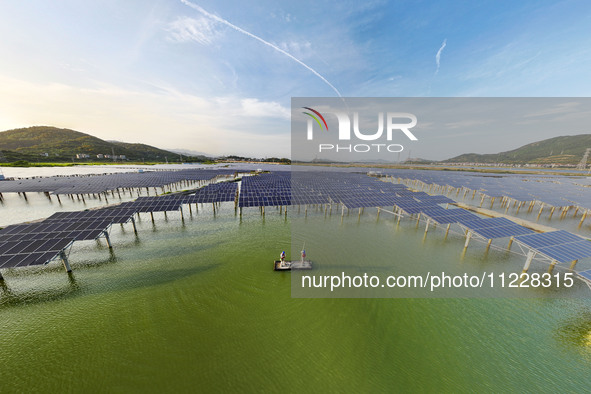 Employees of State Grid Fuzhou Power Supply Company are inspecting photovoltaic equipment in Xincuo town, Fuqing city, Fujian province, Chin...