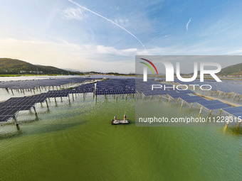 Employees of State Grid Fuzhou Power Supply Company are inspecting photovoltaic equipment in Xincuo town, Fuqing city, Fujian province, Chin...