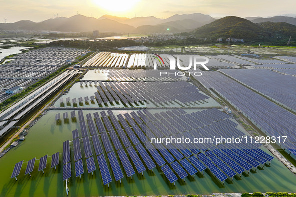 Photovoltaic panels are glowing under the setting sun in Xincuo town, Fuqing city, Fujian province, China, on May 10, 2024. 