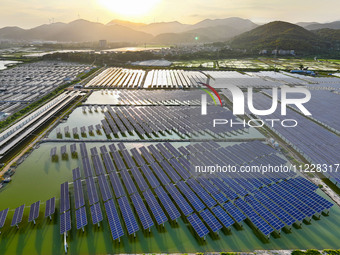 Photovoltaic panels are glowing under the setting sun in Xincuo town, Fuqing city, Fujian province, China, on May 10, 2024. (