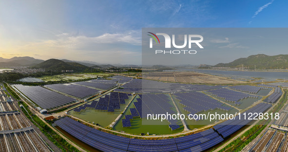 Photovoltaic panels are glowing under the setting sun in Xincuo town, Fuqing city, Fujian province, China, on May 10, 2024. 