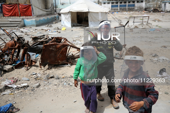 Displaced Palestinian children are playing inside a school where they have taken refuge to set up shelter amid the ongoing conflict between...