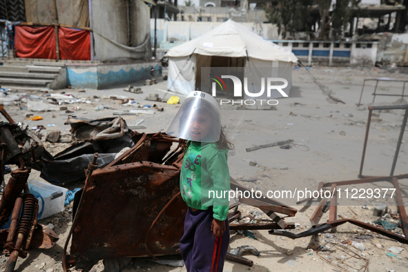 Displaced Palestinian children are playing inside a school where they have taken refuge to set up shelter amid the ongoing conflict between...