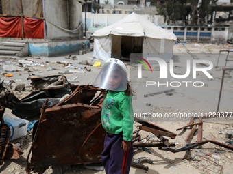 Displaced Palestinian children are playing inside a school where they have taken refuge to set up shelter amid the ongoing conflict between...