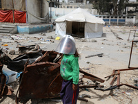 Displaced Palestinian children are playing inside a school where they have taken refuge to set up shelter amid the ongoing conflict between...